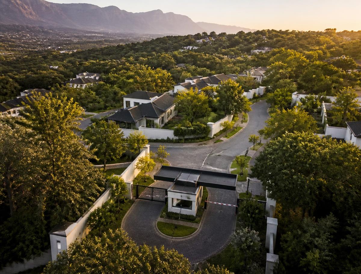 Aerial view of a secure residential estate with a controlled boom gate entrance